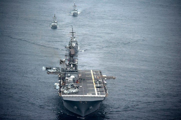 The amphibious assault ship USS America (LHA 6), front, and Peruvian Navy ships sail in formation during a passing exercise in the Pacific Ocean Sept. 3, 2014.  LHA-6 serves similar purpose as Mistral-class amphibious attack ships. Image Credit: CC by U.S Department of Defense/Flickr.